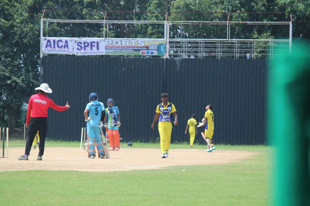 T20 CCL Delhi Selection Camp match on pitch with umpire and players