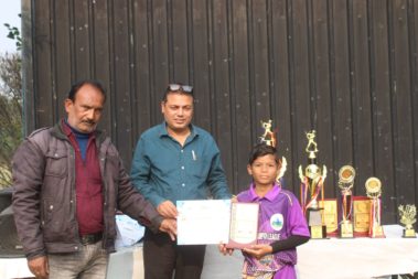 Young player showing certificate