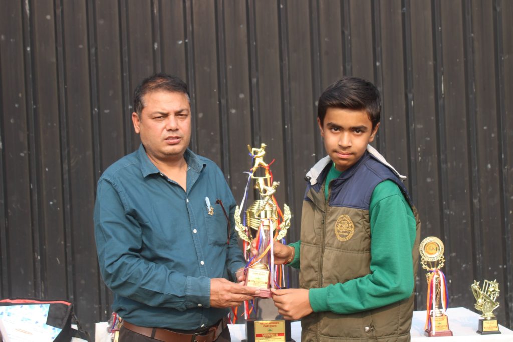 Captain holding golden trophy